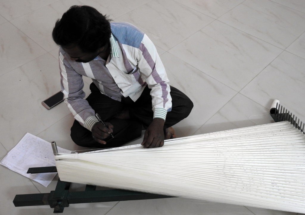 A weaver making the design