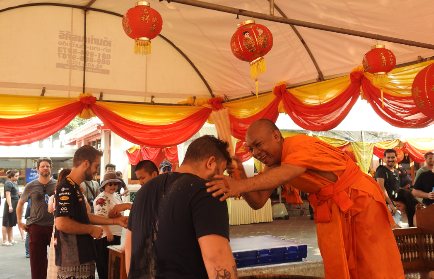 People being blessed by a Buddhist Monk