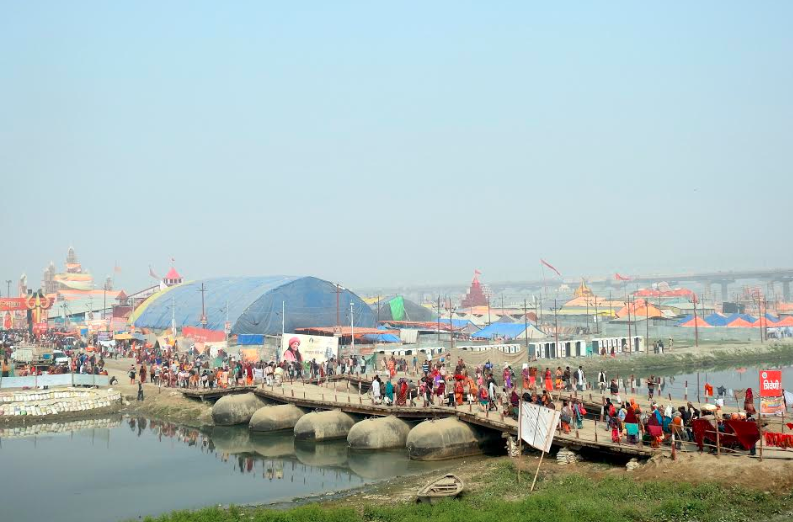 People walking on the pontoon bridge to reach the mela