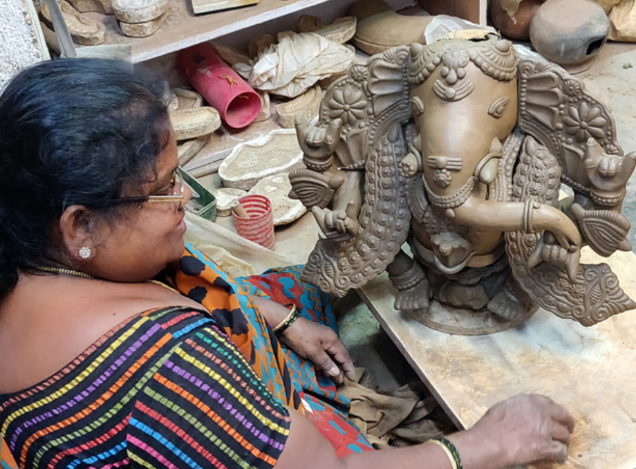 The woman crafting the Ganesha