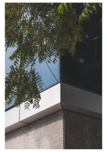 Materiality changes from stone cladding at the entry level to dichromatic glazing